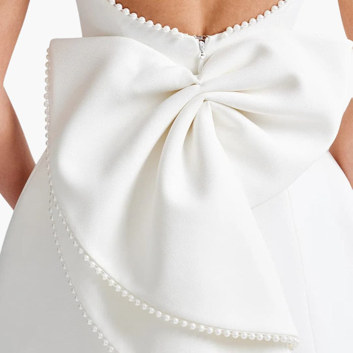 Women’s mini dress with sleeveless cut and pearl embellishments